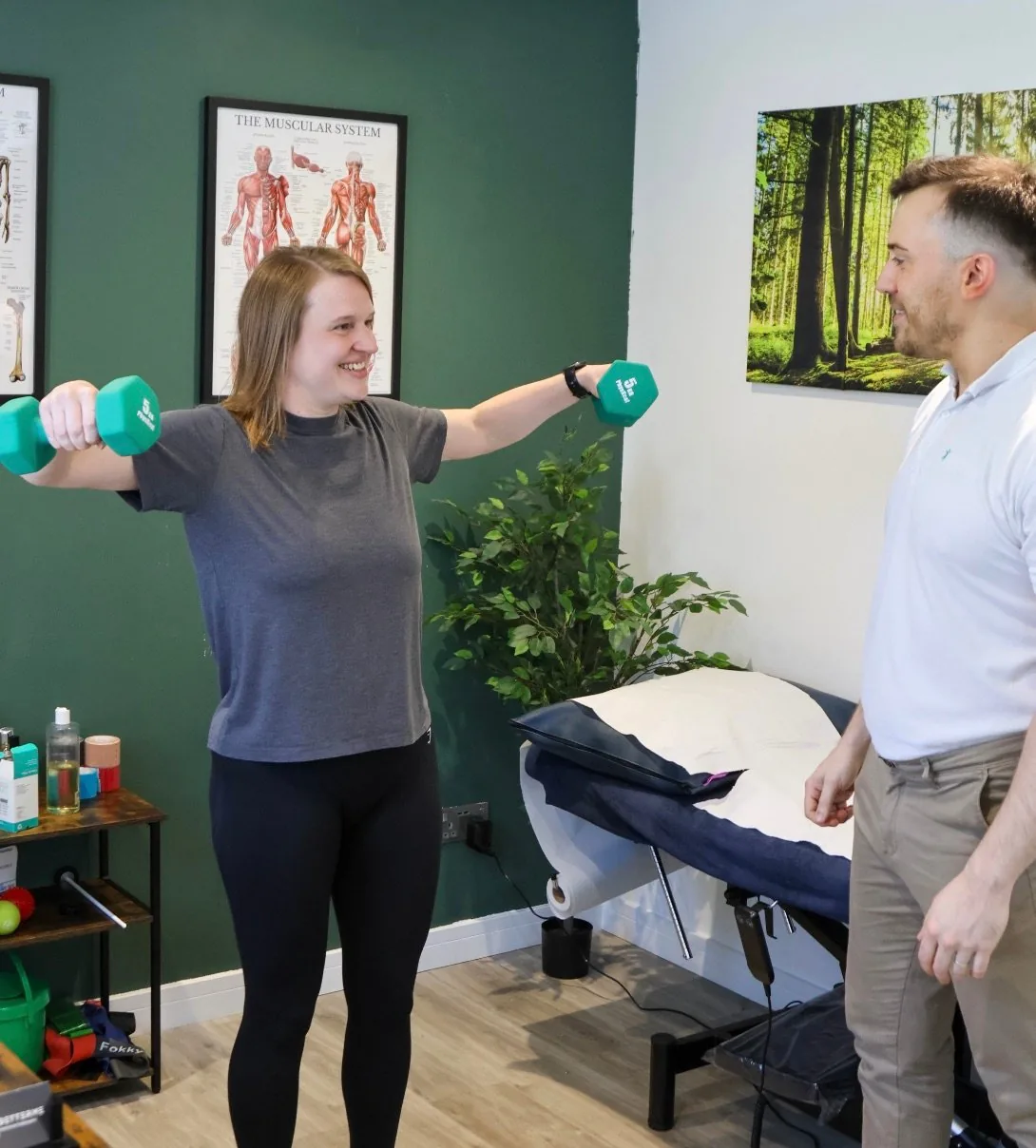 Coaching a shoulder strengthening exercise with dumbbells